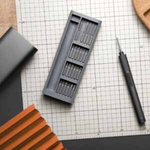 مفك كهربائي دقيق من Xiaomi بلون رمادي، مع جسم أنيق معدني وعلبة تخزين مغناطيسية تضم 24 رأسًا دقيقة من الفولاذ S2 ومقبض مضغوط.